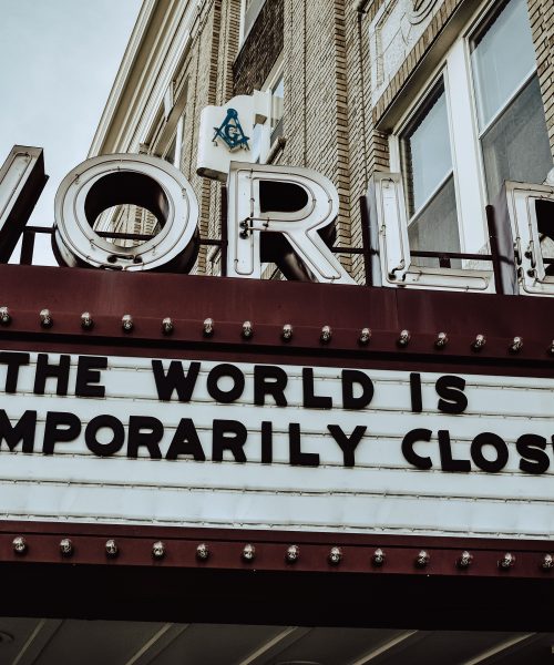 A sign below the World Cinema saying "The world is temporarily closed"