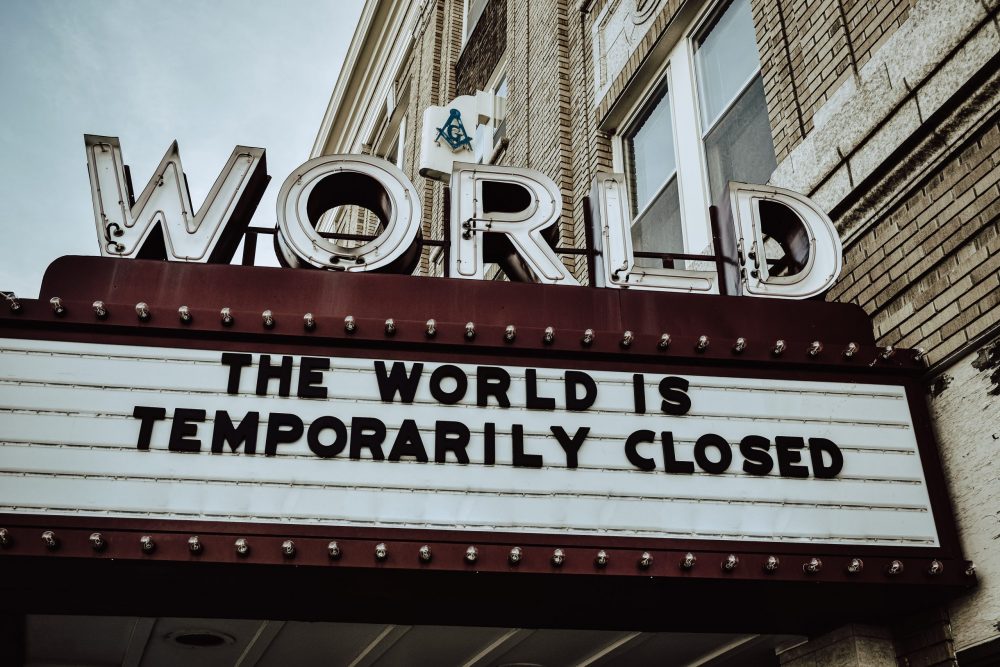 A sign below the World Cinema saying "The world is temporarily closed"